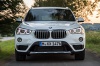 Driving 2019 BMW X1 xDrive28i in Alpine White from a frontal view